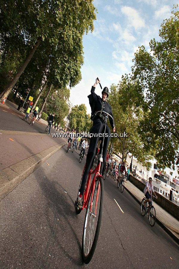 Stilt Walking Policeman on Stilt Bicycle